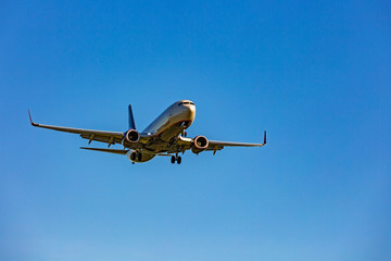 Large passenger plane flying in the blue sky