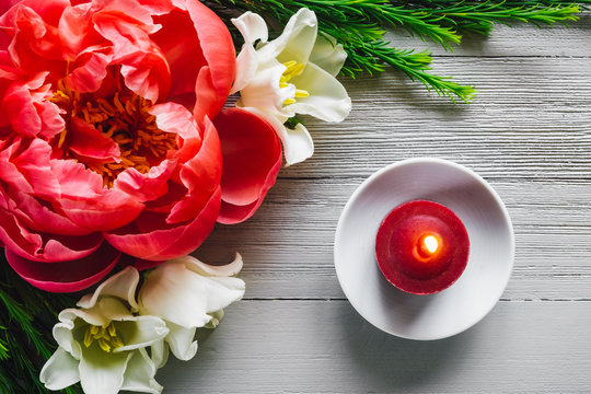 Red Candle on White Table with Tulip and Peony Flowers