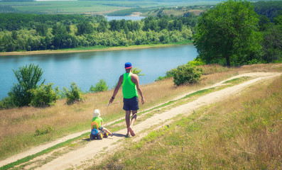 father walks with a child in the nature