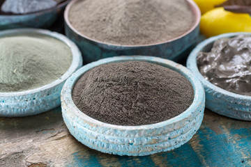 Ancient nature minerals, different types of clay used for skincare, spa treatments, face masks, gray, black, green and blue mud, close up