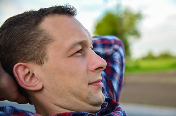 
the man folded his hands behind his head and rested