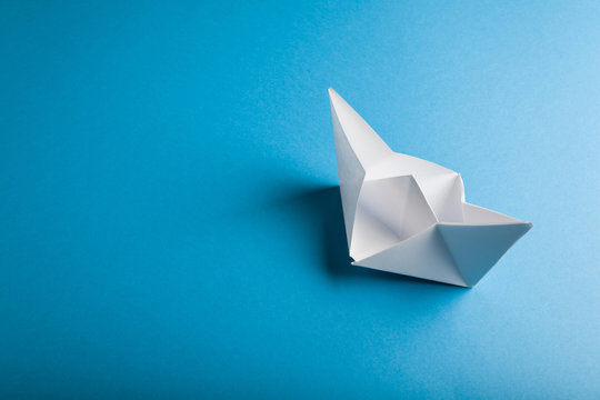 boat paper origami on the blue background