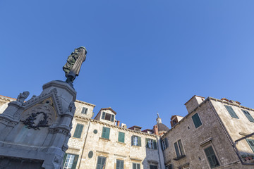 Fototapeta na wymiar Statue and Dubrovnik Cathedral Dome.