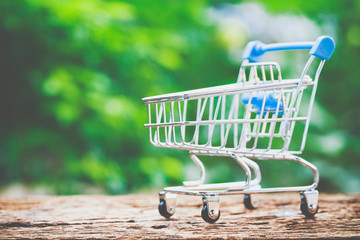 Shopping online concept, The trolley on wood. Customer can buy everything from office or home.