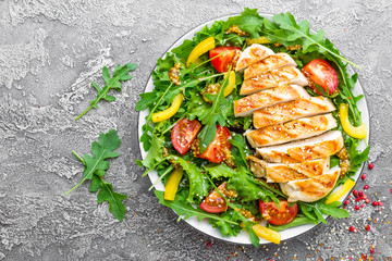 Chicken salad. Meat salad with fresh tomato, sweet pepper, arugula and grilled chicken breast. Chicken fillet with fresh vegetable salad