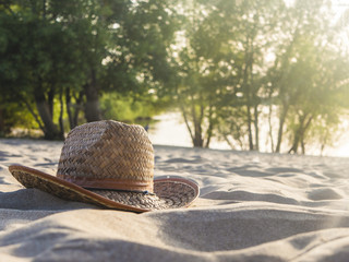 Fototapeta na wymiar summer travel holidays weekend concept, lady hat on the ocean coast on sand