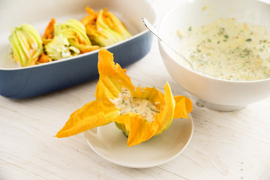 Zucchini  Or Courgette Flowers Are Filled With Ricotta Cream, Preparing A Mediterranean Appetizer On A White Wooden Table