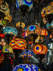 Amazing and elegant photo of ornate and colourful Turkish lights hanging from the ceiling.