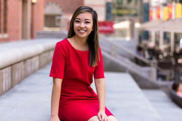 Single beautiful female in bright red dress sitting for a nice conversation