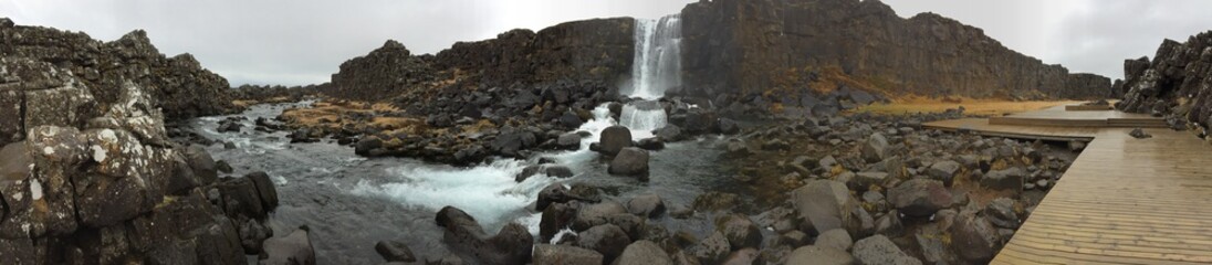 PANORAMA PHOTOGRAPH OF A WATERFALL IN ICELAND IN PINGVELLIR NATIONAL PARK  