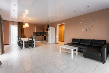 dining table for ten people. Modern minimalism style drawing-room interior. Simple and inexpensive living room with kitchen. daylight in the morning