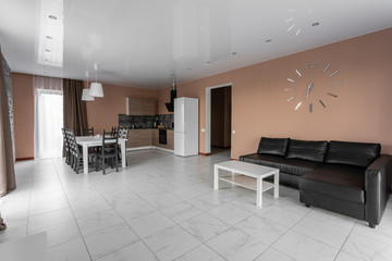 dining table for ten people. Modern minimalism style drawing-room interior. Simple and inexpensive living room with kitchen. daylight in the morning