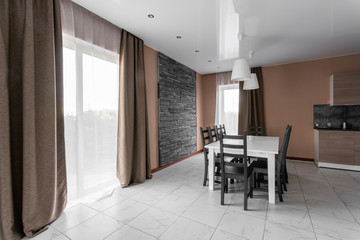 dining table for ten people. Modern minimalism style drawing-room interior. Simple and inexpensive living room with kitchen. daylight in the morning