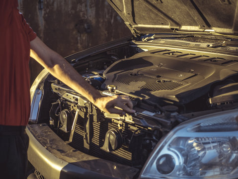 Man Closing The Car Hood After Fixing The Motor