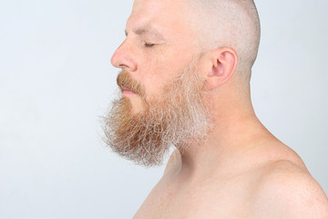 portrait of a bearded man on a light background