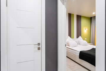 Fototapeta na wymiar Hotel standart room. modern bedroom with white pillows. simple and stylish interior. interior lighting
