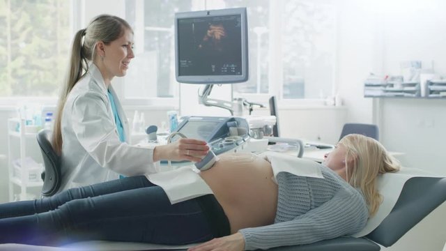 In the Hospital, Pregnant Woman Getting Ultrasound Screening, Obstetrician Checks Picture of the Healthy Baby on the Computer Screen. Shot on RED EPIC-W 8K Helium Cinema Camera.