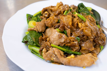 Stir fried ribbon noodle with pork and vegetable