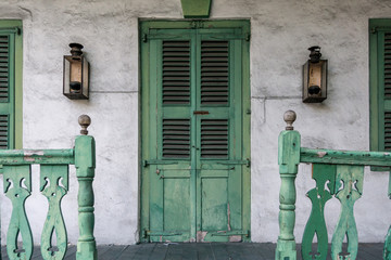 Symmetrical on Front Porch with Green Door and Railing with Lanterns