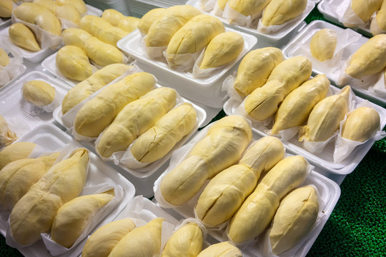 Pieces of durian fruit in white foam plate on display for sale.