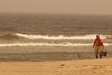 Fisherman on the shore at the beach