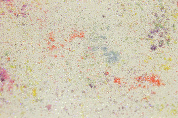 White shiny textured acrylic paint background with glitter and Pink,Yellow,Green,Blue,Purple and Orange pigments background