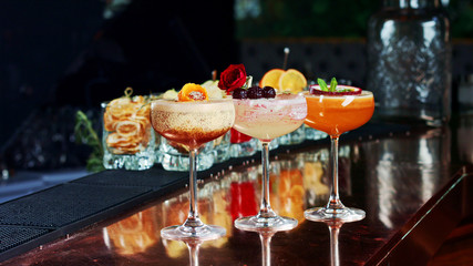 three exquisite cocktails at the bar