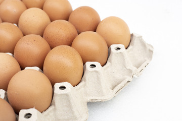fresh eggs in tray on white background
