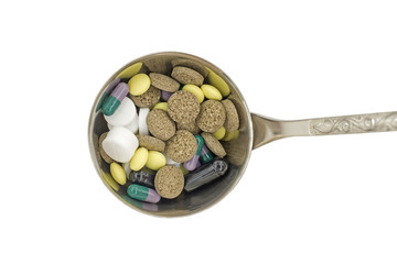 Capsules and tablets in big  spoon