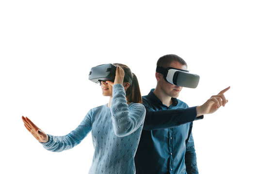 A young woman and a young man in virtual reality glasses on a white background. The concept of modern technologies and technologies of the future. VR glasses.