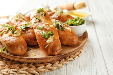 Plate with delicious homemade garlic bread on table