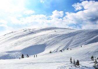 Ski slope at snowy resort on winter day