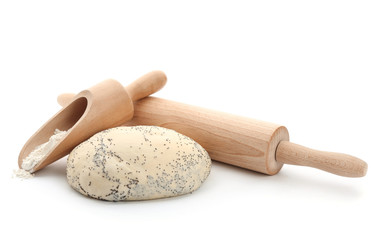 Raw dough with poppy seeds, rolling pin and scoop on white background