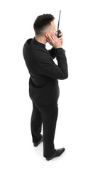 Male security guard using portable radio transmitter on white background