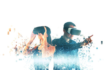 A young woman and a young man in virtual reality glasses are fragmented into pixels.The concept of...