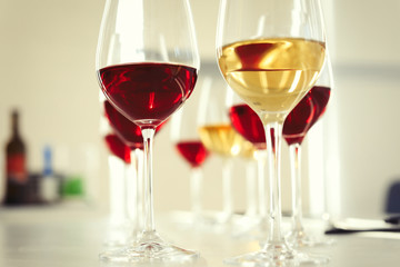 Glasses with delicious wine on table indoors