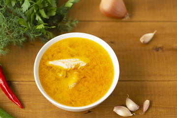 Fresh fish soup with ingredients and spices for cooking. Wooden background