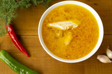 Fresh fish soup with ingredients and spices for cooking. Wooden background