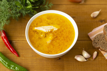 Fresh fish soup with ingredients and spices for cooking. Wooden background