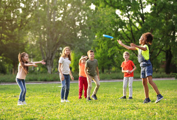 Cute little children playing with frisbee outdoors on sunny day - Powered by Adobe