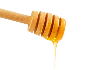 honey with wooden drizzler isolated on white background