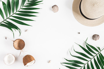 Summer composition. Tropical palm leaves, hat, coconut on white background. Summer concept. Flat...