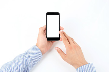 Young man holding mobile phone with blank screen in hand on white background