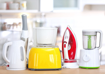 Household and kitchen appliances on table indoors. Interior element