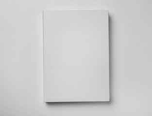 Mockup of hardcover book on white background, top view