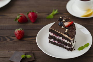 Delicious chocolate cake with strawberries on a plate