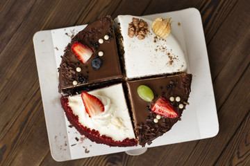Four different pieces of cake. On a wooden table. Top view close-up 