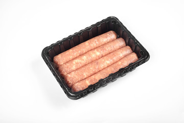 Package of raw sausages isolated on white background