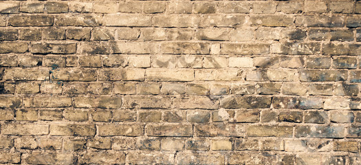 Old brick wall with graffiti fragments