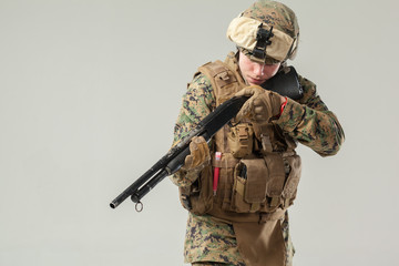Fototapeta premium Soldier in camouflage holding rifle